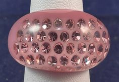 a pink ring with lots of diamonds on it