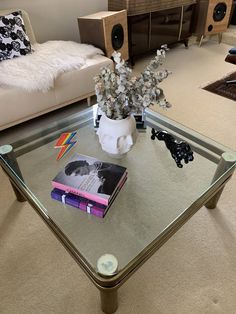 a glass coffee table with books on it