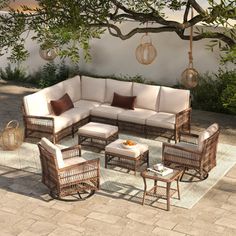 an outdoor living room with wicker furniture