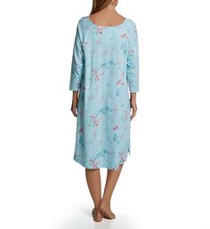 Long-sleeved gown is the pinnacle of grace and elegance with its vivid floral print, smocking detail at top, and shell button closure. Rounded neckline has self-bound edge. Mother-of-pearl buttons close at top center. Smocking above the bust has floral lace accent across the top. Front of gown has ruching for an expansive fit. Long, raglan sleeves feature self-lined edges. Venting at lower sides allows you to move around with ease. Soft jersey knit is made with 100% cotton. Gown has vibrant flor Long Sleeve Floral Print Nightgown For Spring, Floral Print Sleep Dress, Spring Sleepwear With 3/4 Sleeves, Sleeved Gown, Sleeve Gown, Long Sleeve Gown, Rounded Neckline, Mother Of Pearl Buttons, Pearl Buttons