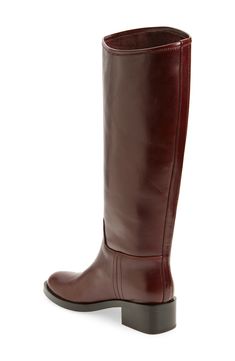 Every wardrobe craves this classic leather riding boot crafted with an asymmetric topline and framed with a rounded toe and chunky block heel. 1 3/4" heel; 1/2" platform 15 3/4" shaft; 15 1/2" calf circumference Pull-on style Leather upper/leather and textile lining/synthetic sole Imported Brown Boots Low Heel, Brazil Festival, Burgundy Knee High Boots, Brown Leather Knee High Boots, Brown Knee High Boots, Tall Leather Boots, Riding Boot, Chunky Block Heels, Leather Riding Boots