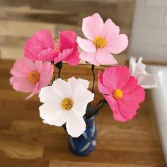 pink and white flowers in a blue vase