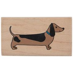 a wooden stamp with a dachshund dog on it's front side