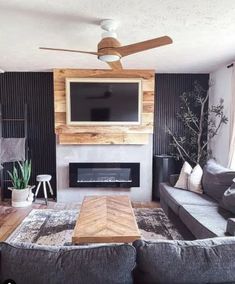 a living room with two couches and a flat screen tv mounted on the wall