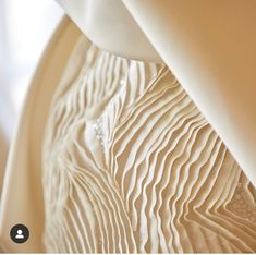 a close up view of a white dress with wavy lines on the bottom and sides