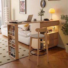 a living room filled with furniture and a laptop computer on top of a wooden desk