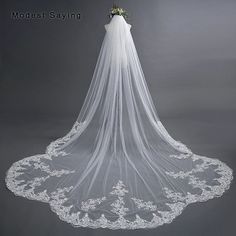 a wedding veil with flowers on the top is shown in front of a gray background