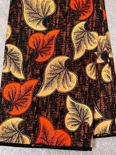 an orange and black leaf print fabric