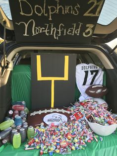 the back of a car with footballs and confetti on it