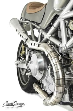 the front end of a silver motorcycle on a white background