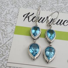 Swiss Blue Topaz Beautiful Earrings. Nice size Stones. Lovely Ornate handwork on bezel Length 1.70 inch Stone Size 10x7mm 9x6mm Blue Topaz Gemstone Earrings For Anniversary, Anniversary Blue Topaz Gemstone Earrings, Silver Topaz Earrings With Gemstone Accents, Topaz Anniversary Earrings With Gemstone Accents, Topaz Earrings For Pierced Ears, Blue Topaz Dangle Earrings Fine Jewelry, Nickel Free Blue Topaz Earrings For Anniversary, Sapphire Blue Topaz Earrings For Pierced Ears, Turquoise Blue Topaz Jewelry Set With Matching Earrings