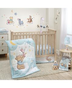 a baby's room with winnie the pooh crib bedding