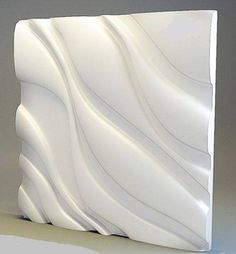 an abstract white sculpture is shown against a gray background