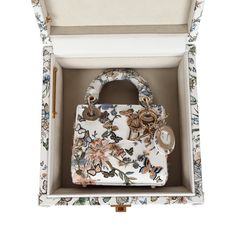 This Limited Edition Christian Dior Mirco Lady Dior Bag is in White/Multicolored Embroidered Calfskin with Light Gold Hardware, features butterfly and flower garden motif with 3D-like embroidered flowers and butterflies all over bag, tonal stitching, DIOR logo charm hanging from bag, two flat leather top handles, flap closure and removable shoulder strap. The Micro Lady Dior also comes in a White Multicolored Calfskin Leather Small Trunk. The Trunk also features a butterfly and floral motif in calfskin leather, Antique Gold Hardware, gold studs along the top, side and bottom, gold metal clasp closure, and soft suede/fabric interior.Origin: Italy and FranceCondition: New and never Accompanied by: Dior dustbag, shoulder strap, carebook and trunkMeasurements: Bag: 4.5" x 4.25" x 1.25" and Tru Lady Dior Limited Edition, Luxury Elegant Floral Embroidered Bag, Rare Lady Dior Bag, Dior Butterfly Bag, Christian Dior Floral Bag, Dior Embroidered Bag, Small Lady Dior My Abcdior Bag, Dior Limited Edition Bag, Dior Purse