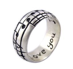 a ring with musical notes on it and the words love is written in black ink