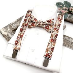 Brunt Orange Floral Suspenders, Rust Orange Bow tie, Suspender Bowtie, Wedding Floral Suspenders, Groomsmen Suspenders, Ring bearer outfit Suspender size : ■ BABY SET (6 - 18 mo): ■ BOW TIE - 3.3" inches (8.5 cm )  Pre-tied and made with adjustable white strap and white plastic clasp. ■ SUSPENDERS - adjustable from 16" to 27". Made of elastic. / Y-shape back. ■ Y-back suspenders of high quality elastic. Adjustable Clip and Elastic straps for you to adjust the length. » Small (6mp - 5 years old s Dapper Suspenders For Wedding, Fitted Suspenders For Groom Suit And Tie Accessories, Dapper Wedding Suspenders, Groom's Bow Tie With Suspenders, Ring Bearer Outfit Suspenders, Copper Suspenders, Floral Tie Suspenders Wedding, Floral Suspenders, Terracotta Bow Tie And Suspenders