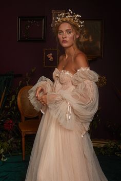 a woman in a wedding dress is posing for the camera