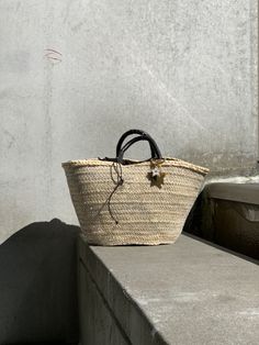 The Brigitte bag is our very modern version of the traditional Panier basket. The basket, handmade by artisans in Spain in palm leaf straw, is covered in a metallic gold mesh, and the short handles coiled in brown leather. It is lined in dark brown cotton fabric, with leather drawstring with metal star charms. The bag is finished with a Cuckoo B keychain featuring a buffalo horn star made in Vietnam, a handmade in Argentina ceramic white star and the Cuckoo B bronze tag. It is inspired on Summer Metal Star, Bag Silver, Metal Stars, White Star, Palm Leaf, Star Charms, Metallic Gold, Black Cotton, Straw Bag