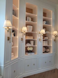 a white bookcase filled with lots of books