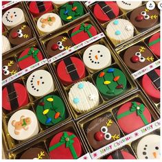 many decorated christmas cookies in boxes on display