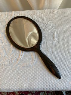 a magnifying glass sitting on top of a white cloth