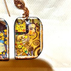 First I coated the copper disks with base enamel on both sides then added 3 layers of cream color opaque Thompsons enamel on front, added the Gustav Klimt decals and refired then touched them up with gold luster enamel and fired again !! I added gold druzy connectors and 14k gold filled ear wires ....earrings are made  with 22 gage copper to be lightweight ... I can add hand-forged sterling silver ear wires on request  item can arrive gift wrapped with a personal note on request FREE SHIPPING Gustav Klimt, Ear Wires, Cream Color, Dog Tag Necklace, Jewelry Earrings Dangle, Gold Filled, Etsy Earrings, Dangle Drop Earrings, Dangle Earrings