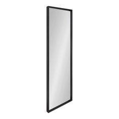 a black framed mirror on a white wall