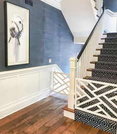 the stairs are painted blue and white in this house with wood flooring on both sides