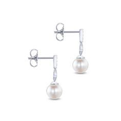 Set in luxurious gold, these classic dangle earrings feature a duo of glossy cultured pearls. Glinting with a total weight of 0.06 carats, round cut diamonds dance across the white gold frame for a delicate touch of shimmer. Earrings dangle just over 3/4 an inch. Pearls measure approximately 7mm wide. Due to the organic nature of mother of pearl, there may be minor variances in color, size and shape from the image Includes earring box Ships fully insured to point of delivery