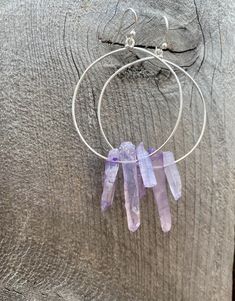 Raw purple quartz crystal points in gold or silver hoop earrings with French hooks. Perfect little boho look. Light weight and easy to wear. Add these to your boho outfits and make a 💜Healing clear quartz Crystal property has been know for centuries to restore balance in the body. -Options- 30mm as shown 21 gauge hoops Total drop Length: 2.3 inches 14k Gold filled hoops Sterling silver hoops Gold plated hoops Silver plated hoops All comes with hooks Simple, Dainty, Delicate, yet so Elegant and Adjustable Gemstone Hoop Jewelry, Unique Dangle Hoop Earrings With Natural Stones, Nickel-free Purple Dangle Hoop Earrings, Purple Nickel-free Dangle Hoop Earrings, Hoop Jewelry With Natural Stones For Gift, Unique Hoop Earrings With Natural Stones, Purple Bohemian Everyday Jewelry, Purple Dangle Hoop Earrings With Ear Wire, Bohemian Wire Wrapped Hoop Crystal Earrings