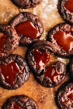 chocolate cookies covered in caramel are on a baking sheet