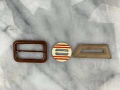 There are 3 belt buckles in this listing. 2 are completely covered, front & back in leather: 1.5" x 2.5" rectangle with metal rod in the middle 1.25" x 2.75" trapezoid, with an opening in the middle. Bakelite circle measures 1 3/8" round. These are perfect to complete vintage costumes. Could also be used as slides on scarves. Scarf Slides, Vintage Belt Buckles, Vintage Belt, Suspender Belt, Vintage Costumes, Suspenders, Belt Buckles, Slides, Angeles