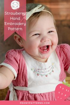 a baby girl laughing with the words strawberry hand embroidery pattern on her chest and bottom