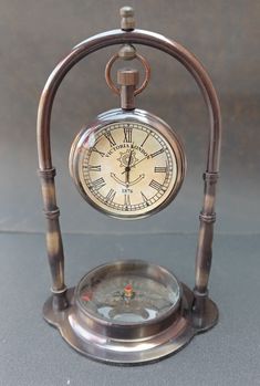 an old fashioned clock is sitting on a table