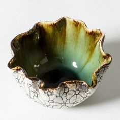 a green and white bowl sitting on top of a table