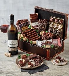 a bottle of wine and some chocolates in a suitcase