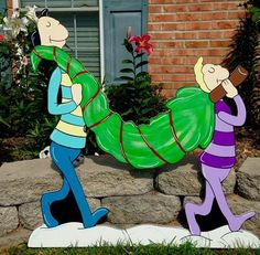 two cartoon characters are walking in front of a house and one is carrying a large green bag