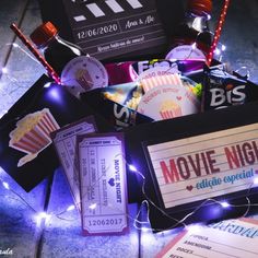 the movie night gift box is filled with movies and snacks, along with some tickets