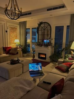 a living room filled with furniture and a laptop computer sitting on top of a table