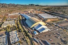 an aerial view of a parking lot with mountains in the background