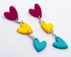 Pansexual Hearts PINK, YELLOW, BLUE LGBTQIA+ Pride Polymer Clay Dangle Drop Earrings and stainless steel chain and posts Jewellery is Handmade with every detail carefully refined to ensure the best quality.  Due to the handmade nature of the items there may be slight variations from piece to piece and perfect "imperfections" All earrings come with clear rubber backing Measurements: 60mm x 12mm *measurements are approximate and made vary slightly per piece ---------------------------------------- Pan Pride, Love Jewelry, Lgbt Pride, Gay Love, Handmade Jewellery, Heart Jewelry, Handmade Polymer Clay, Jewelry Handmade, Stainless Steel Chain