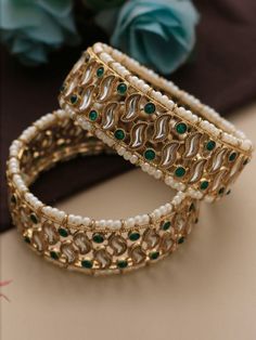 Indulge in the timeless elegance of these Kundan and pearl green stone  Rajwada bangles, exquisitely crafted to adorn your wrists with regal charm. These ethnic kadas epitomize traditional Indian craftsmanship, intricately designed to enhance any ensemble, be it for a lavish Indian wedding or a Pakistani Nikaah ceremony. Elevate your jewelry collection with these stunning bracelets, capturing the essence of heritage and luxury. Comes in pair ( 2 bangle kadas) Each bangle weighs 35 gms approx Kundan Cutdana Bangle For Wedding, Cutdana Kundan Bangle For Wedding, Traditional Wedding Bangle With Stone Work, White Kundan Bangle For Wedding, Hand Set Bangle For Wedding And Diwali, Wedding Bangle With Cutdana For Diwali, Festive Bridal Bangle Sets With Stone Work, Hand Set Bangle For Wedding During Diwali, Wedding Green Meenakari Chandbalis