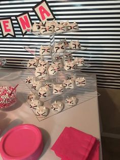 a table topped with lots of cupcakes covered in white frosting