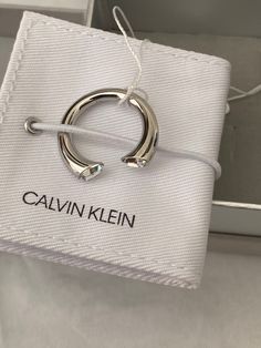 Calvin Klein Brilliant This Calvin Klein ring is very gorgeous on the fingers.    The clear stone makes it stand out. Calvin Klein embossed on the ring. Open ended ring.  Comes with box and pouch. Calvin Klein Products, Amethyst Open Ring For Anniversary, Metal Open Ring Diamond Ring For Anniversary, Calvin Klein Accessories, Open Metal Crystal Ring For Anniversary, Modern Crystal Ring For Gift, White Gold Crystal Open Ring As Gift, White Gold Open Ring Crystal For Gifts, Luxury Crystal Open Ring