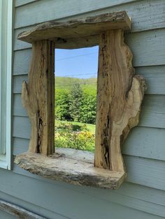 a mirror made out of wood on the side of a house