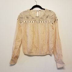 Nwot, Free People Slightly Cropped Crochet Top With Boho Stitching, Weaving, Beading & Sequined Details. Colors Of Cream, Tan, And Bronze. Long Cuffed Sleeves. Elastic At Hem And Also Along The Detailing On Shoulder. Beautiful! Armpit To Armpit 21" Length 21" Beaded Long Sleeve Summer Blouse, Beige Embellished Blouse, Bohemian Embellished Long Sleeve Blouse, Bohemian Long Sleeve Embellished Blouse, Long Sleeve Embellished Blouse For Festivals, Embellished Long Sleeve Blouse For Festival, Boho Stitching, Boho Blouse, Crochet Crop Top