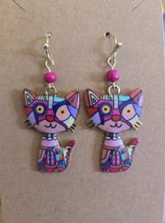 Meow!  This is a delightful pair of patchwork kitty cat earrings.  The finish is light gold in color. Cute Cat Design Drop Earrings, Cute Cat Ears Earrings With Cat Print, Pink Cat Design Earrings With Cat Ears Shape, Pink Cat Design Jewelry With Cat Ears, Cat Earrings, I Love Cats, Kitty Cat, Cats And Kittens, Jewelry Earrings Dangle