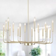 a large chandelier with many lights hanging from it's sides in a living room