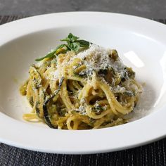 a white plate topped with pasta covered in sauce