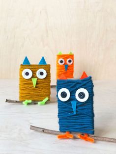 two yarn owls sitting next to each other